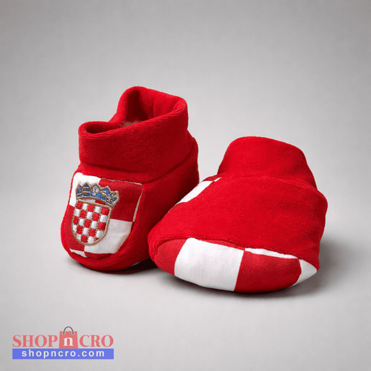 Baby Slippers Croatia in Red Red baby booties with a crest design on a gray background