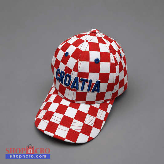A red and white checkered baseball cap with 'CROATIA' embroidered in blue on the front, photographed on a neutral gray background. Baseball Cap Team Croatia 2 shopncro