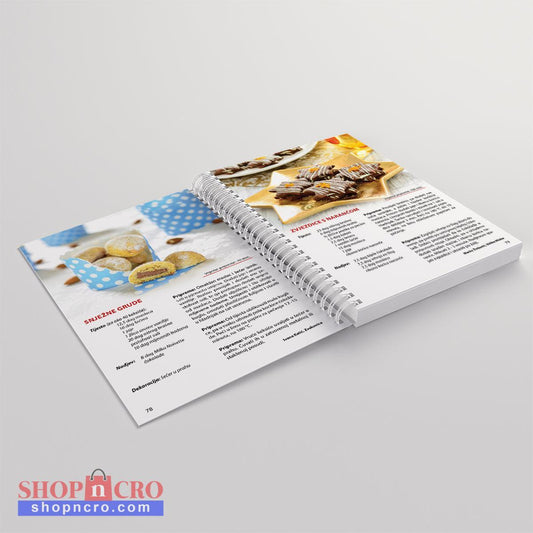 Kolači, čarolija užitka 2 Open cookbook showing recipes and images of desserts on a light gray background