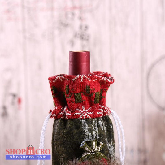 Christmas Bottle Cover – Santa, Snowman & Reindeer Decorative bottle with a red knitted cover featuring green patterns on a blurred background shopncro