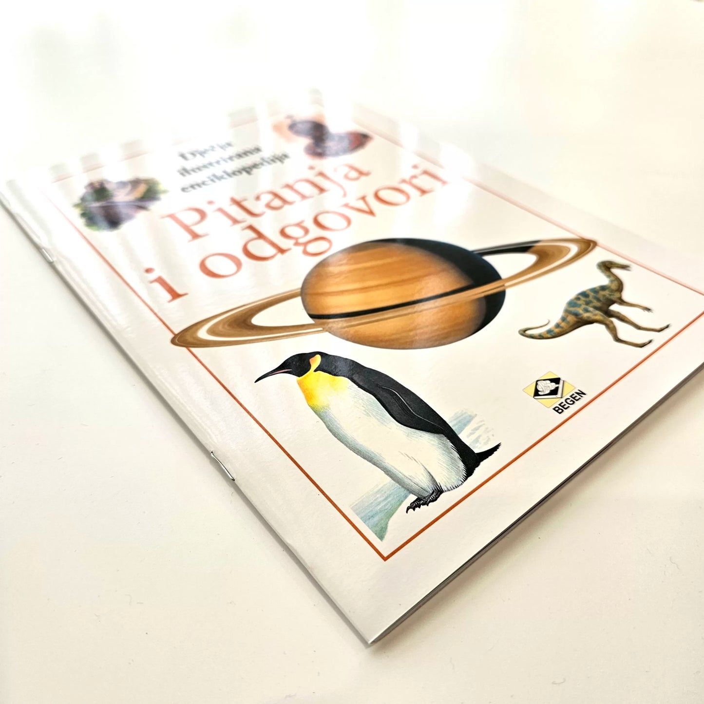 Dječje Ilustrirane Enciklopedije – Pitanja i Odgovori Book cover with a penguin, planet, and text on a light background