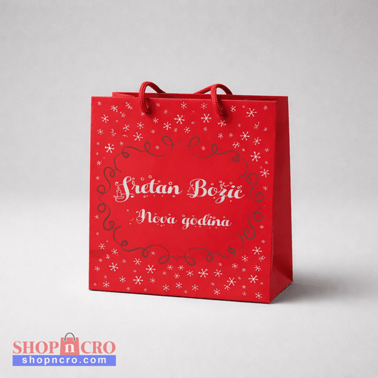 Festive Gift Bag – Sretan Božić Red gift bag with white text and snowflake patterns on a light gray background