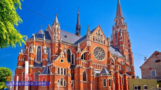 Fortress Churches in Croatia (English) Gothic-style church with red brick facade under a clear blue sky