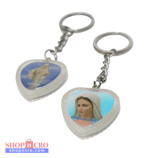 Heart-Shaped Catholic Keyring - Virgin Mary of Medjugorje Heart-shaped keychain with images of a dove and a religious figure on a white background
