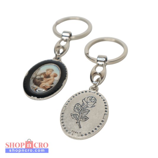Keyring Saint Anthony of Padua – Double-Sided Religious Medal (Black Enamel) Keychain with circular pendant featuring a rose design and another pendant with an image of a woman.