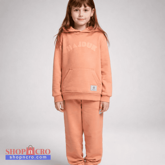 Child wearing a peach-colored hoodie and pants with 'MAJOR' branding on a gray background Kids Tracksuit Hajduk