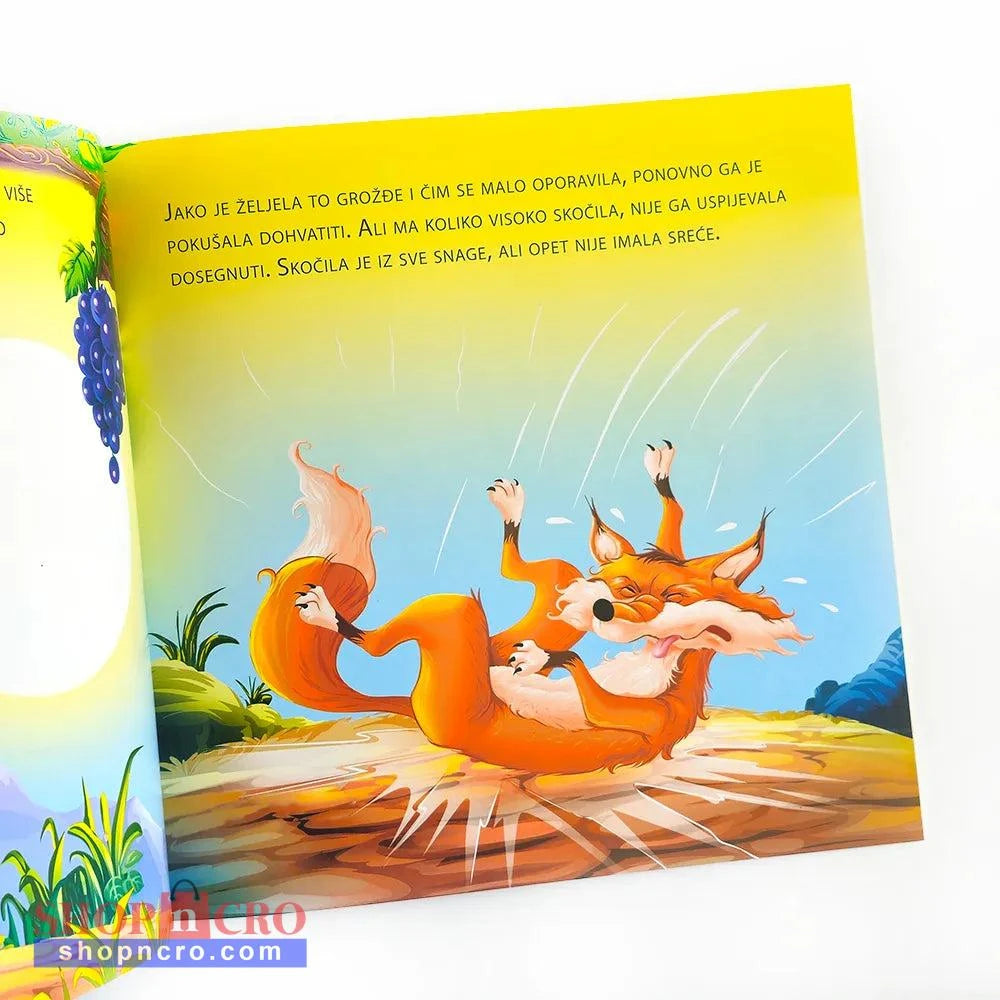 Lisica i Grožđe Illustrated book page with a fox character on a colorful background