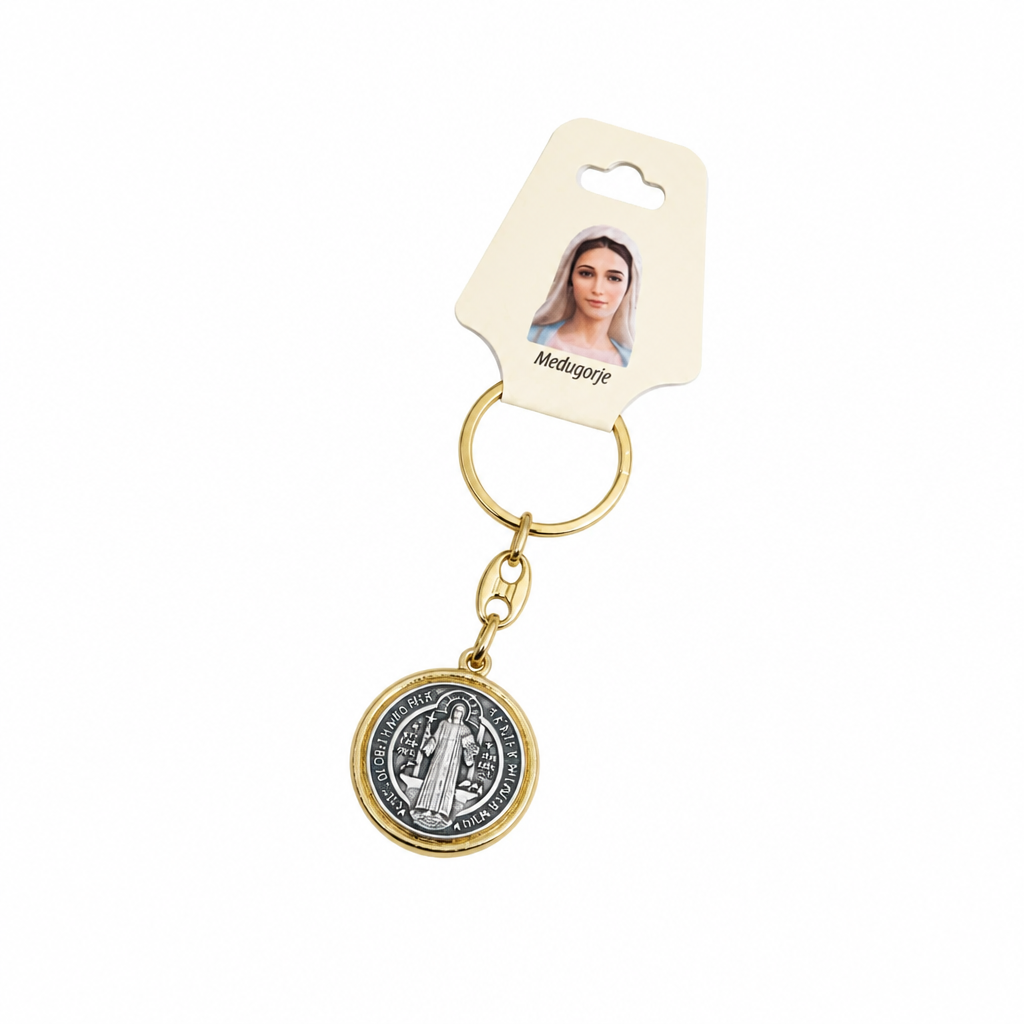 Međugorje Keyring Saint Benedict Medal in Gold Gold heart-shaped pendant with 'M' on a beige background