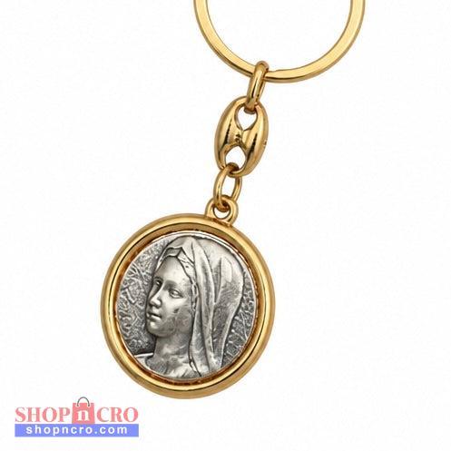 Međugorje Keyring Virgin Mary in Gold A gold-tone keychain featuring a circular pendant with an embossed silver-tone profile of a classical figure, shown on a plain white background.