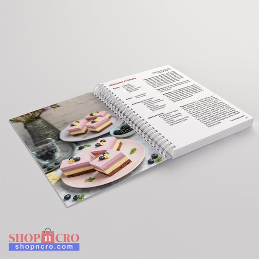 Moji Kremasti KOLAČI Open cookbook showing a recipe for heart-shaped desserts on a gray background