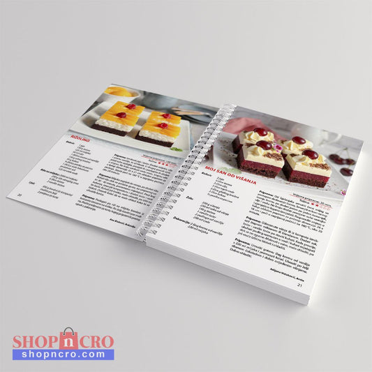 Moji Voćni Kolači Open cookbook showing pages with dessert recipes and images on a light gray background