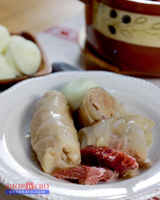 Croatian Classics: Cookbook in English Language Stewed dish with meat and vegetables on a white plate, with a blurred background - Sarma