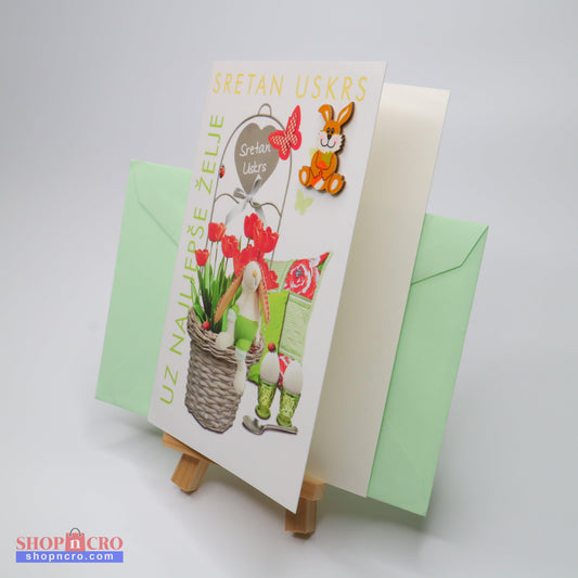 Sretan Uskrs Bunny 3D Easter Greeting Card Easter-themed greeting card with a basket of flowers and a green envelope on a white background