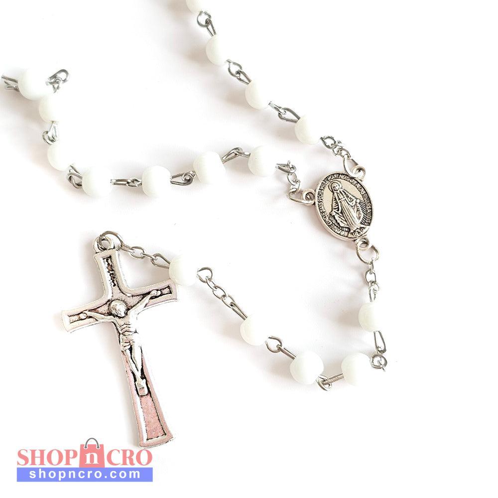 White Bead Catholic Rosary with Silver Crucifix and Virgin Mary Medal White rosary with silver cross and other charms on a white background