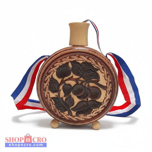 Wooden decorative item with engraved design and ribbons on a white background