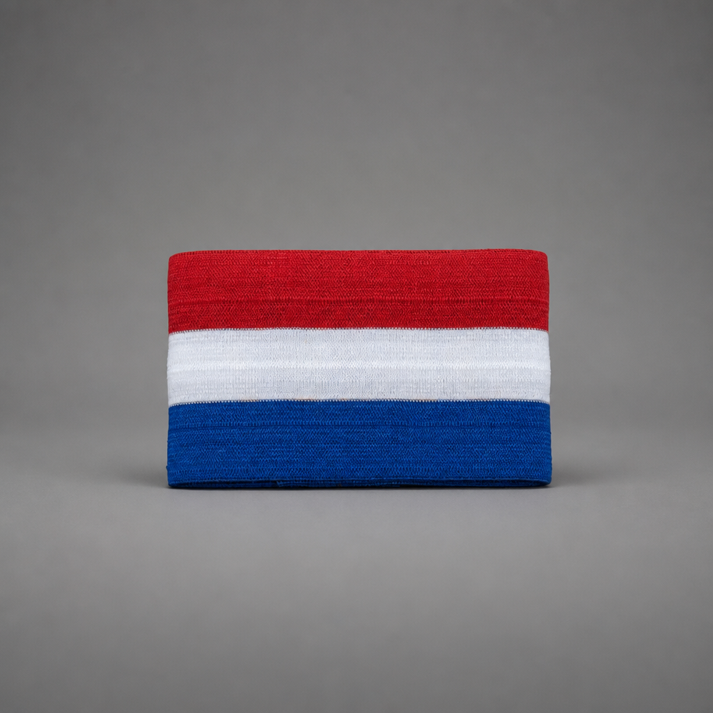 A rectangular knit fabric item, likely a headband or wristband, featuring horizontal stripes of red, white, and blue, centered on a solid gray background. Croatia Captain Armband