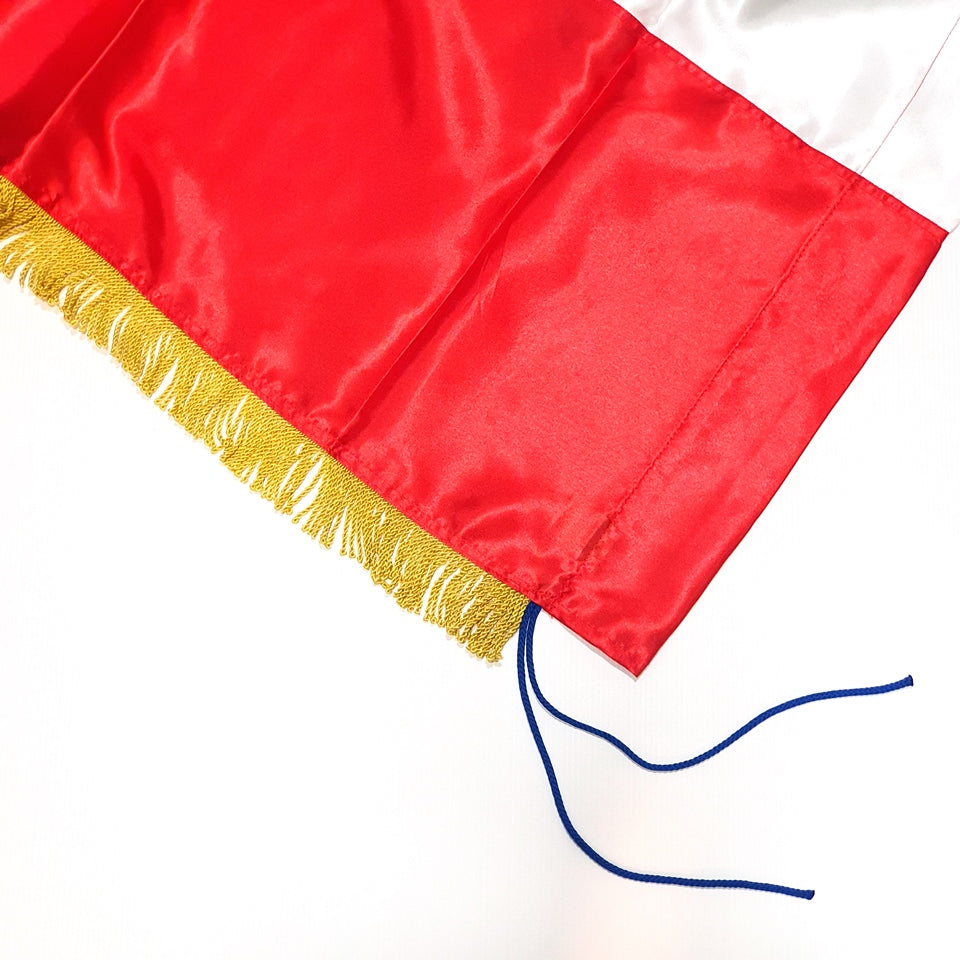 Croatian Historic Silk Flag Prvo Bijelo Polje 200cm by 100cm Close-up of a red flag with gold fringe and blue tassel on a white background