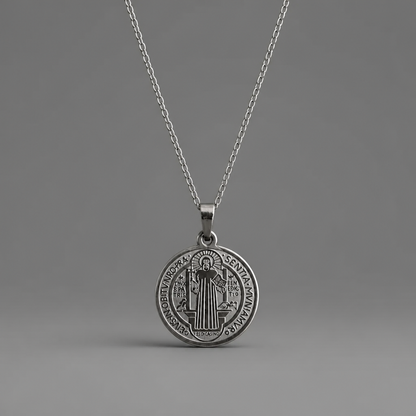 Croatian Medallion Necklace – St. Benedict Catholic Pendant A silver Saint Benedict medal pendant necklace on a matching silver chain, displayed against a neutral gray background.