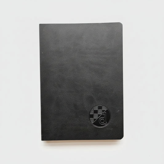 Black notebook with a circular logo on a white background