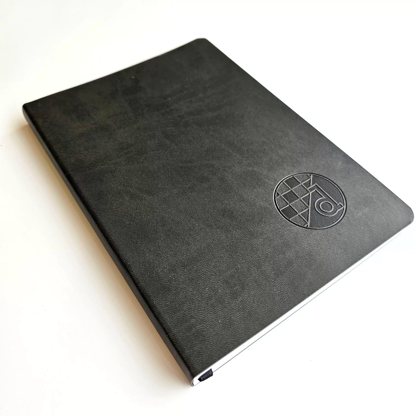 GNK Dinamo B5 Writing Book / Note Pad – Black Marble Edition Black notebook with a logo on a white background