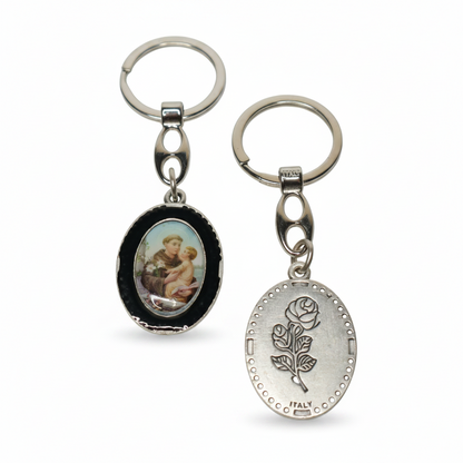 Keyring Saint Anthony of Padua – Double-Sided Religious Medal (Black Enamel) Two keychains with different designs on a white background