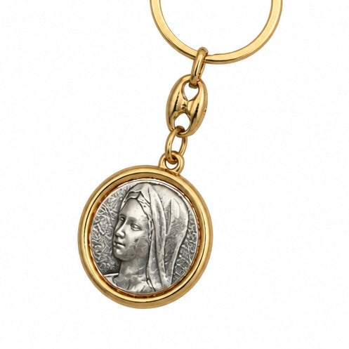 Međugorje Keyring Virgin Mary in Gold A gold-tone keychain featuring a circular pendant with an embossed silver-tone profile of a classical figure, shown on a plain white background.
