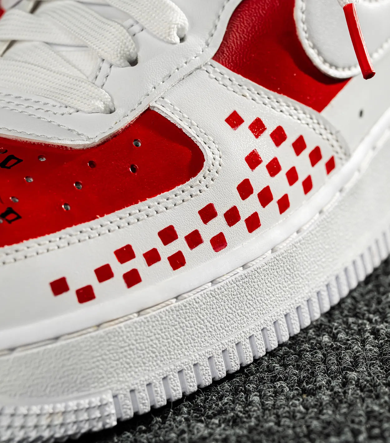Nike Air Force 1 CROATIA HNS Close-up of a white sneaker with red accents on a gray surface