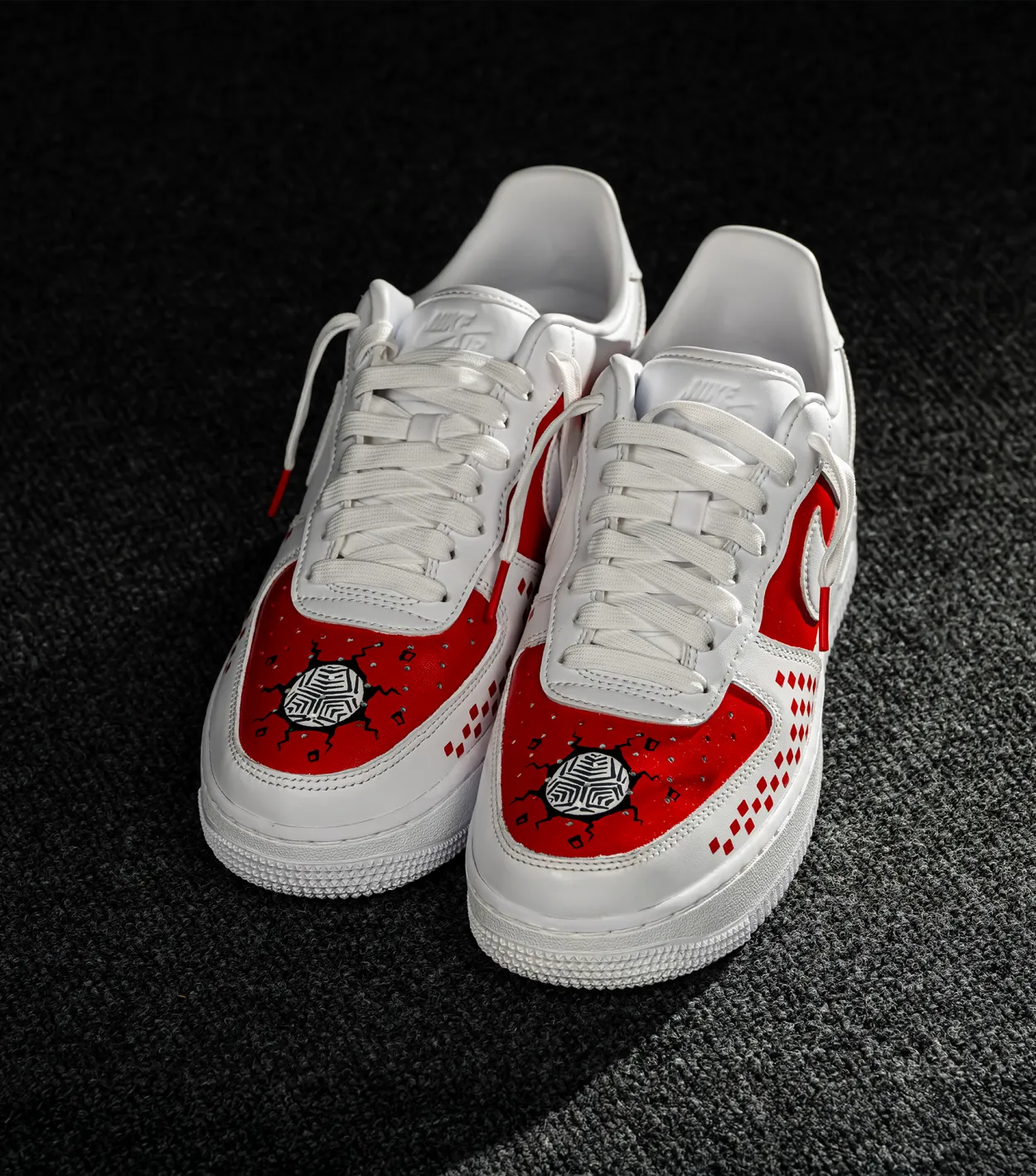 Nike Air Force 1 CROATIA HNS White sneakers with red accents and black patterns on a dark textured surface