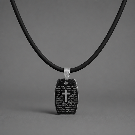 Oče Naš Necklace Black pendant with cross and text on a black cord against a gray background