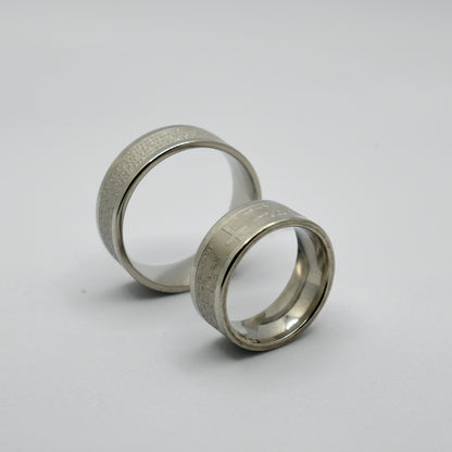 Oče Naš Ring – Silver Finish (17 – 22 Sizes) Two silver rings with size labels on a white background