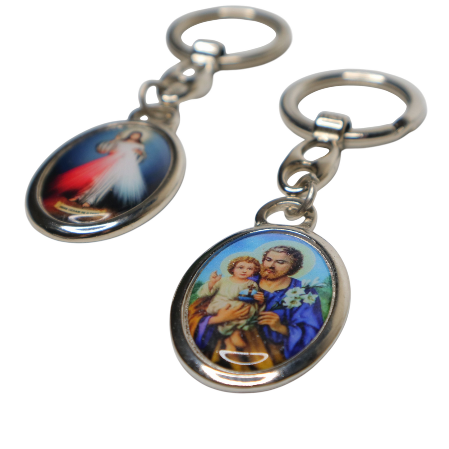 Two keychains with religious-themed designs on a white background
