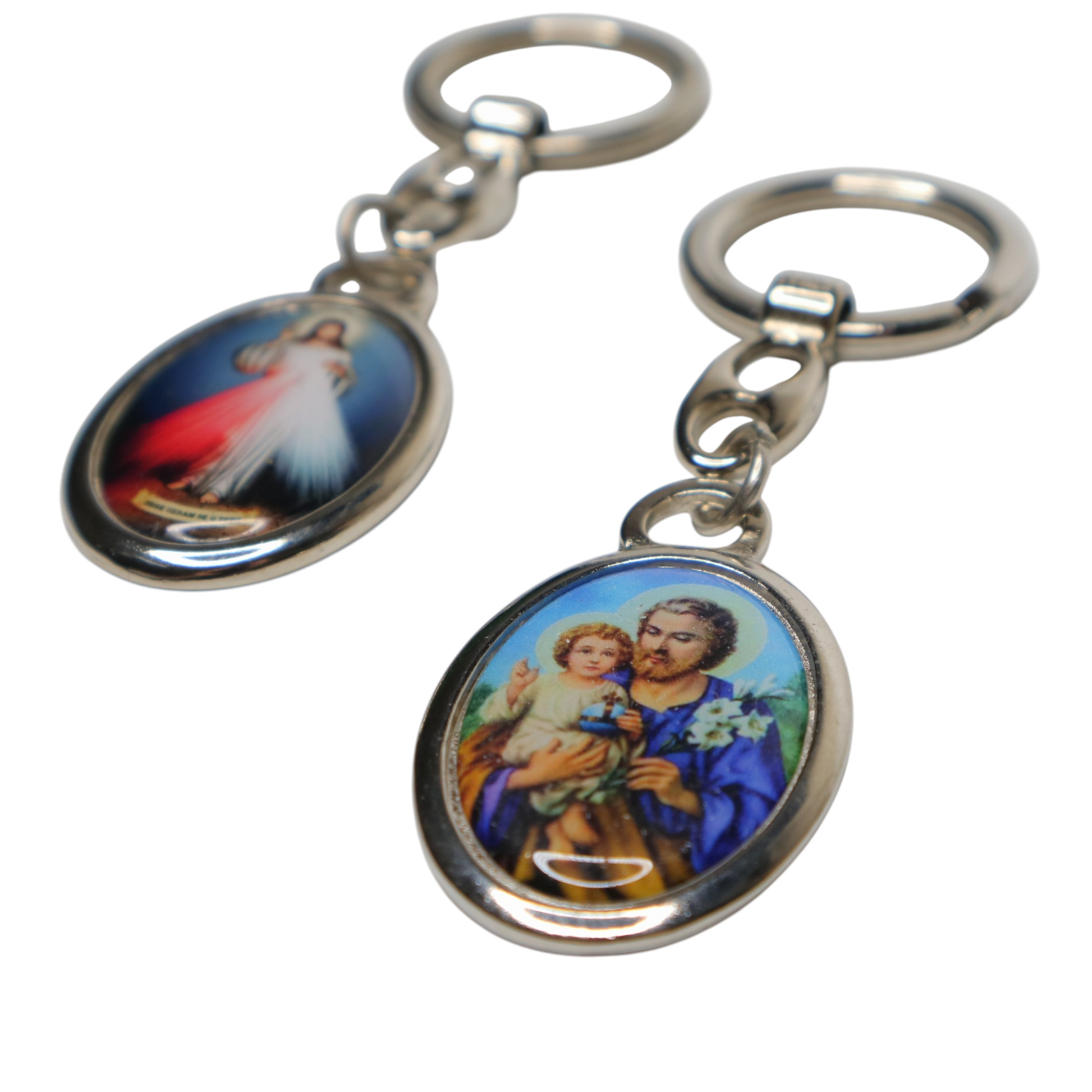 Two keychains with religious-themed designs on a white background