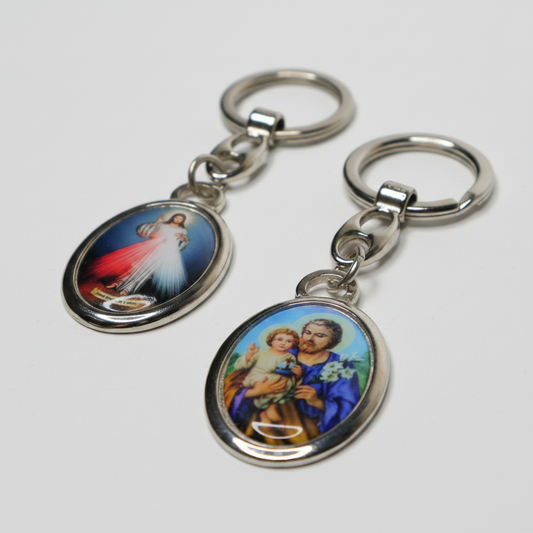 Two keychains with religious-themed designs on a white background