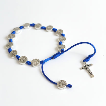 Saint Benedict Adjustable Bracelet with Cross (Blue) Blue and silver beaded necklace on a white background