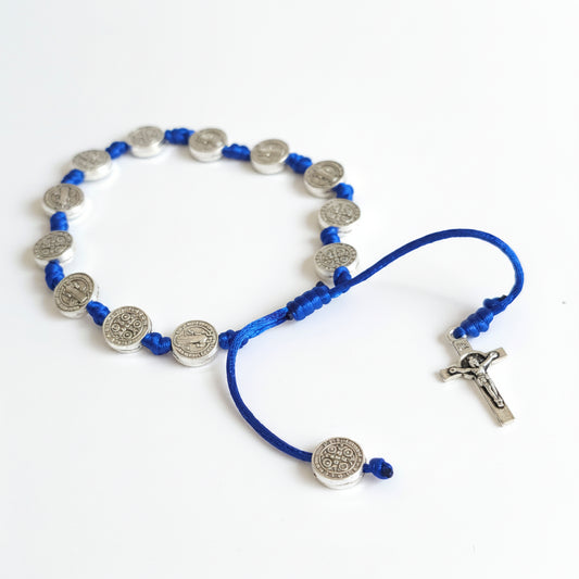 Saint Benedict Adjustable Bracelet with Cross (Blue) Blue and silver beaded necklace on a white background