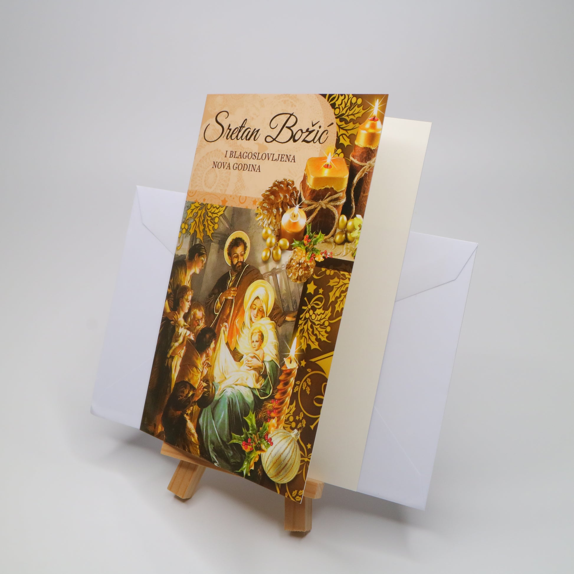 Sretan Božić Golden Christmas Greeting Card Decorative greeting card with religious design on a stand, featuring a white envelope.