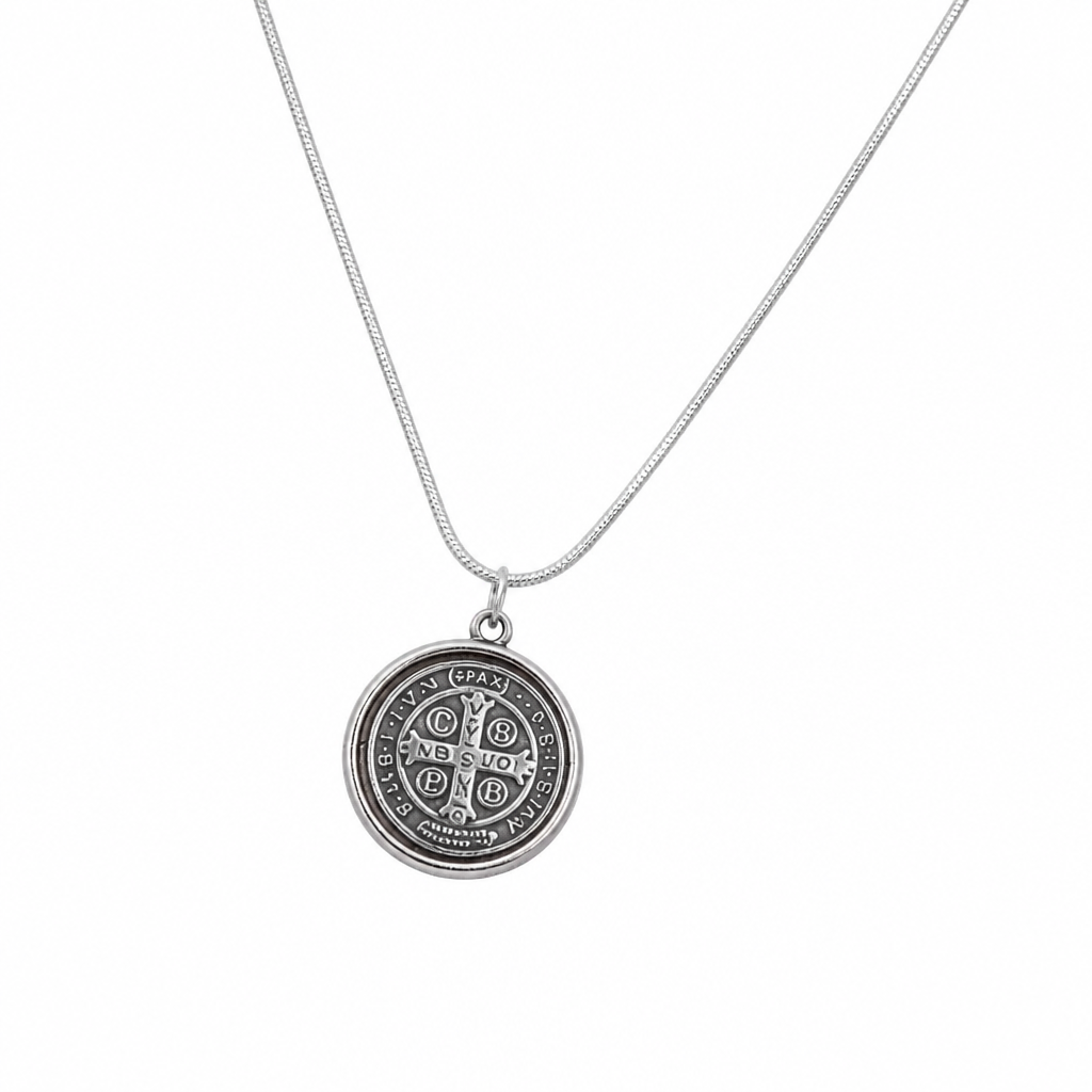 St. Benedict Medal | Pendant + Necklace or Pendant only A silver pendant necklace featuring a circular Saint Benedict medal on a delicate silver chain, set against a plain white background.