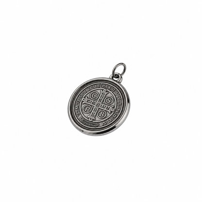 St. Benedict Medal | Pendant + Necklace or Pendant only A round silver-toned metal pendant featuring an embossed religious design with a central cross and surrounding text, shown on a plain white background.