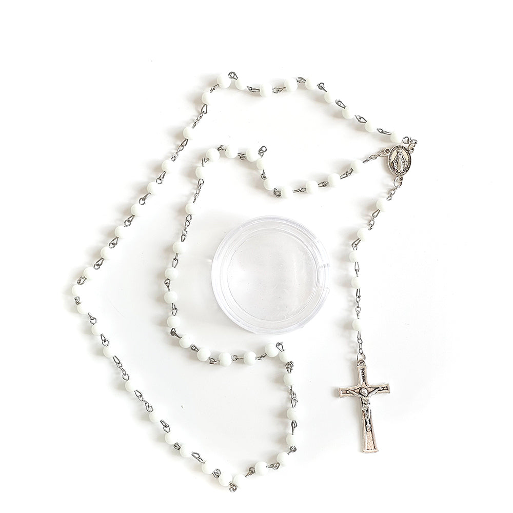 White Bead Catholic Rosary with Silver Crucifix and Virgin Mary Medal Silver rosary with a crucifix on a white background