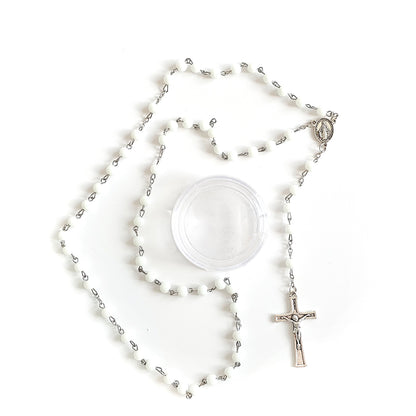 White Bead Catholic Rosary with Silver Crucifix and Virgin Mary Medal Silver rosary with a crucifix on a white background