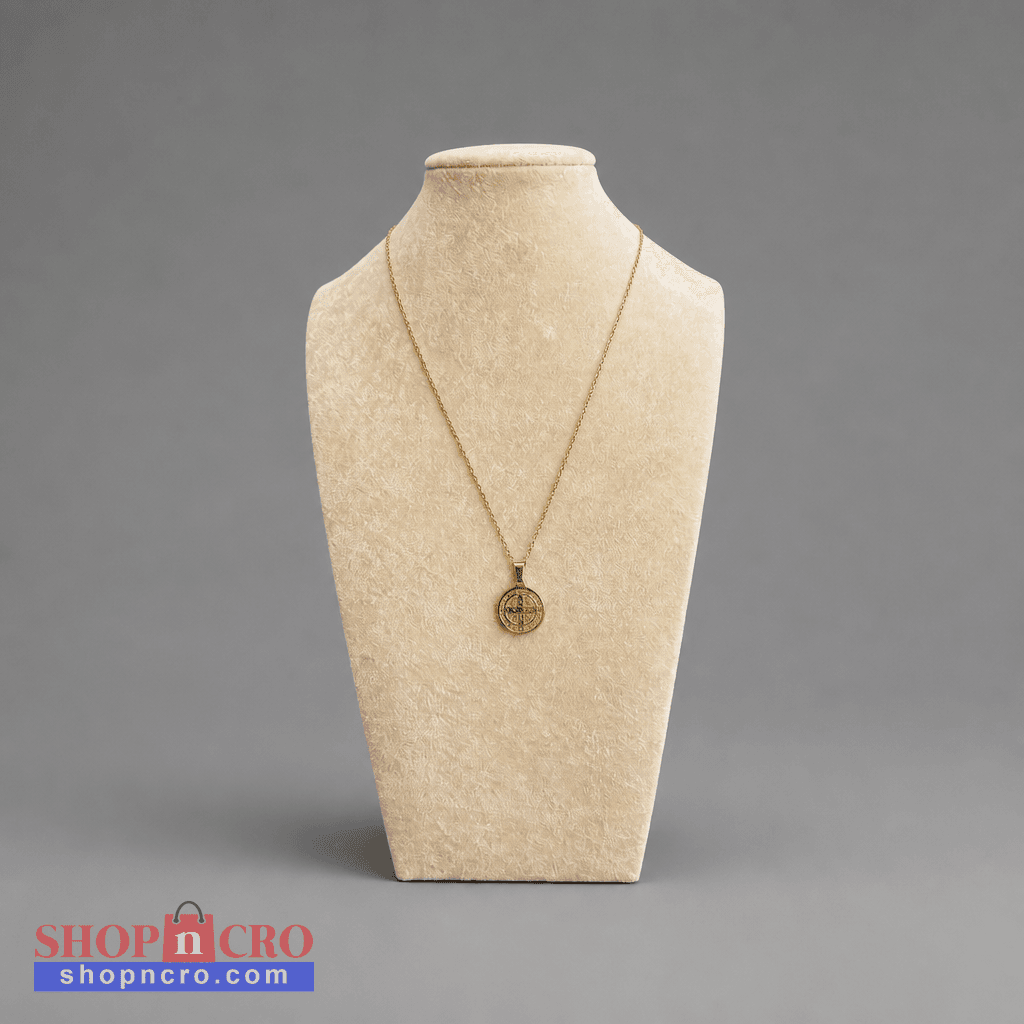 Croatian Medallion Necklace – St. Benedict Pendant (gold chain) A gold pendant necklace displayed on a beige fabric jewelry bust against a neutral gray background. The pendant is a circular medallion with a cross design.